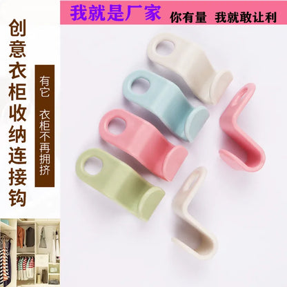 Plastic single hook hanger made of ABS material for wardrobe organization and garment drying; lightweight stackable design suppo
